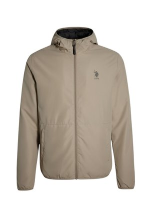 Giacca leggera beige con cappuccio, chiusura a zip e due tasche laterali. Presenta una fodera interna nera e un logo sul petto.