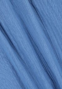 Lightweight, textured fabric in a soft blue hue, featuring a subtle, crinkled pattern that adds depth and dimension.