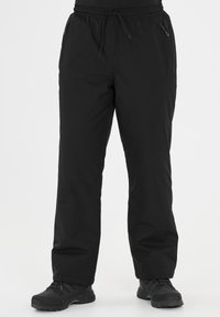 Pantalons d'extérieur noirs en matériau léger, dotés d'une taille élastique, de deux poches latérales zippées et d'une coupe droite.