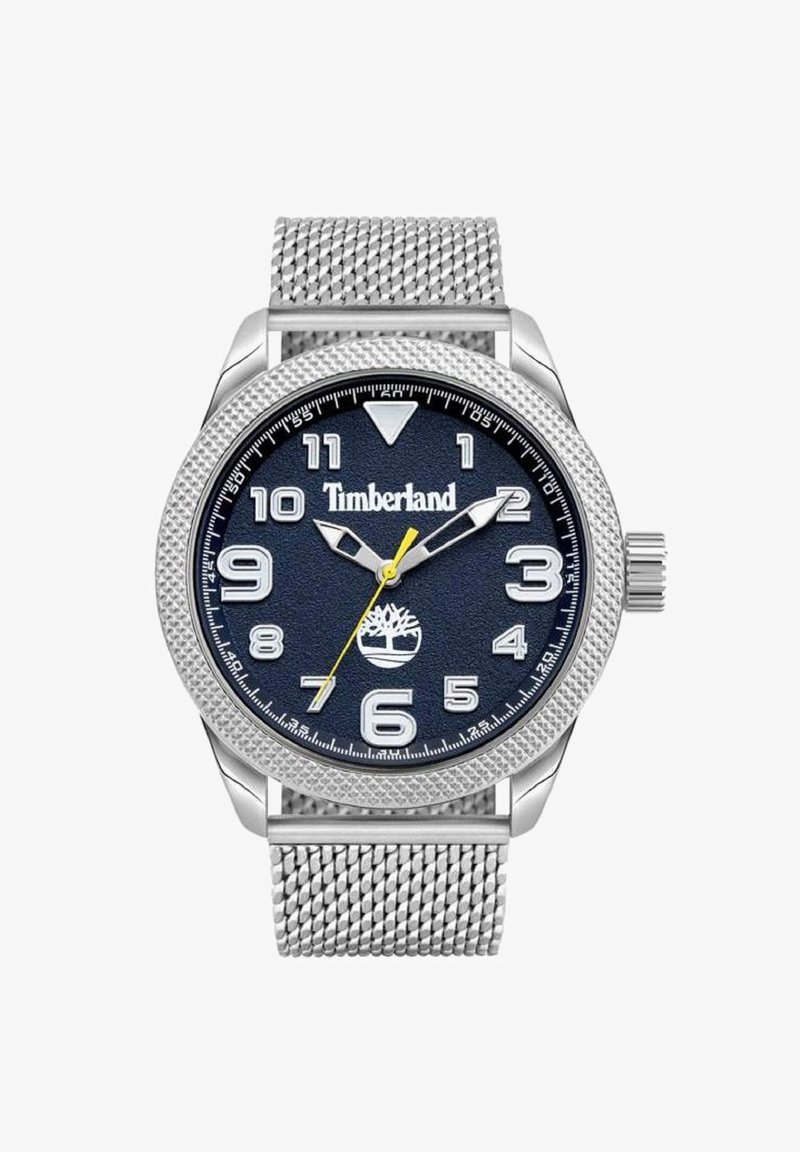 Srebrny zegarek na siateczkowym pasku z granatową teksturowaną tarczą, białymi cyframi i żółtą wskazówką sekundową. Na tarczy znajduje się logo Timberland.