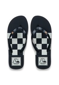 Σαγιονάρες με ασπρόμαυρο καρό σχέδιο, υφασμένο πέλμα, μαύρα λουράκια και στρογγυλό διακοσμητικό λογότυπο στη σόλα. Κλασικός σχεδιασμός για παραλία.