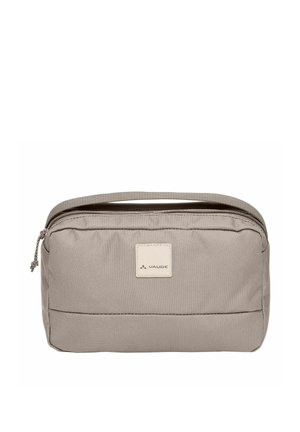 Compact beige reistoilettas met ritssluiting en draaghendel, voorzien van een klein Vaude-logo op de voorkant.