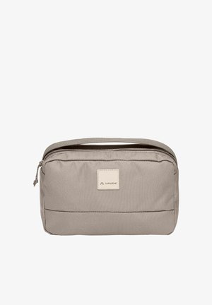 Trousse de toilette de voyage compacte beige avec fermeture éclair et poignée de transport, arborant un petit patch logo Vaude sur le devant.