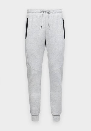 Grijze joggingbroek met een trekkoord in de taille, voorzien van zijzakken met rits, taps toelopende benen en contrasterende zwarte accenten op de zakken.