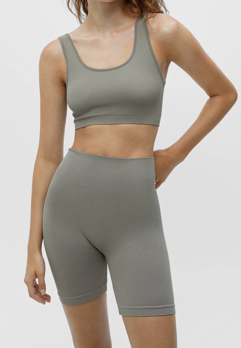 Gray ribbed sports bra and high-waisted shorts set, featuring a seamless design with a soft texture and minimalistic cut.