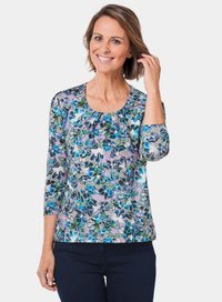 Bluse mit floralem Print in Blau- und Grüntönen, aus weichem Stoff. Mit Dreiviertelärmel und rundem Halsausschnitt.