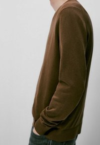 Maglione marrone, con texture, maniche lunghe e polsini a coste, dotato di un collo rotondo e una vestibilità rilassata. Vista laterale.