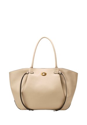 Beige læder tote taske med lange håndtag, detaljer med snørelukning i siden og et lille gyldent ovalt logo foran i midten.