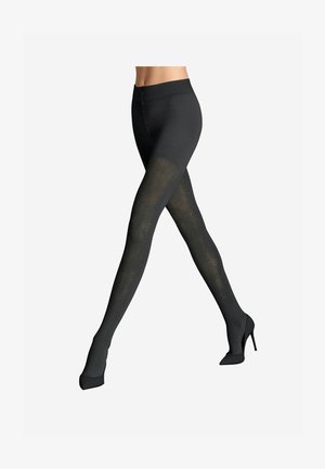 Collants noirs à motifs avec un design en filet texturé, ceinture lisse et apparence semi-opaque, associés à des escarpins noirs.