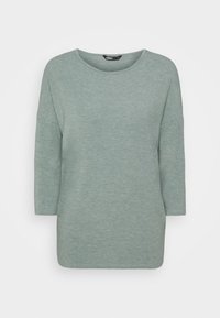 Vaaleanvihreä, pitkähihainen paita, jossa on pyöreä kaula-aukko, valmistettu pehmeästä, tekstuurista kankaasta; rento malli, jossa on laskeutuneet hartiat ja ei näkyviä kuvioita.