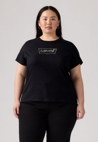 T-shirt noir à manches courtes avec col rond et logo Levi's brodé en or. Tissu en coton doux, coupe décontractée, design minimaliste.