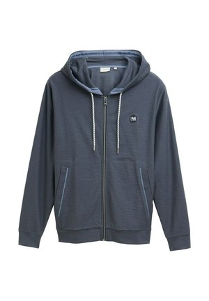 Hoodie zippé bleu foncé en tissu texturé, avec capuche à cordon de serrage réglable, deux poches avant et un petit logo sur la poitrine.