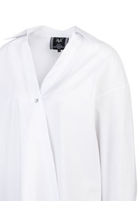 White, long-sleeved shirt with a collar, featuring a button closure and smooth fabric. Includes brand label inside the neckline.