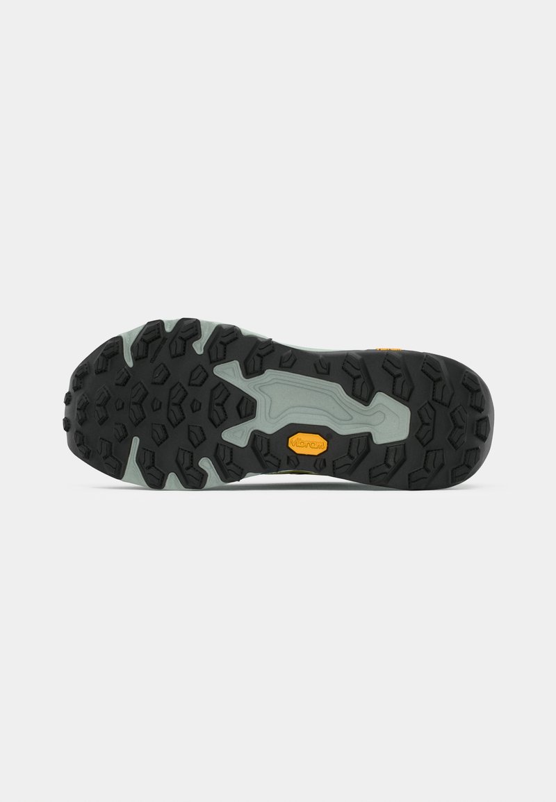 Vibram-soled footwear with a textured black rubber outsole, combines gray and yellow elements with deep treads for traction.