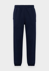 Mørkeblå joggebukser med elastisk midjebånd og mansjetter, rett benpassform, vist mot en ensfarget lys bakgrunn.