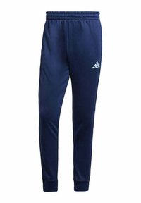 Pantalones deportivos de poliéster azul marino con cintura elástica, ajuste tapered y logo blanco de Adidas en la pierna izquierda. Textura suave para mayor comodidad.