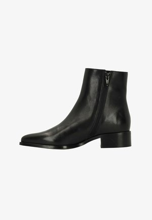 Black leather ankle boot with side zipper, low block heel, and pointed toe, displayed against a white background.