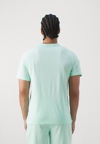 Jordan TOP - Sports T-shirts - mint foam/black