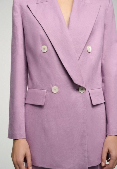 Lavender linen double-breasted blazer with two large cream buttons, sharp lapels, and flap pockets. Smooth texture with minimal stitching details.