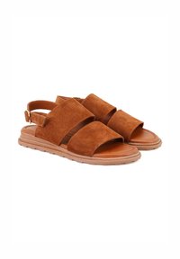 Braune Wildleder-Sandalen mit einem doppelten Riemendesign, offener Zehenpartie und einer gepolsterten Sohle mit einer strukturierten Gummisohle. Verstellbarer Fersenriemen.