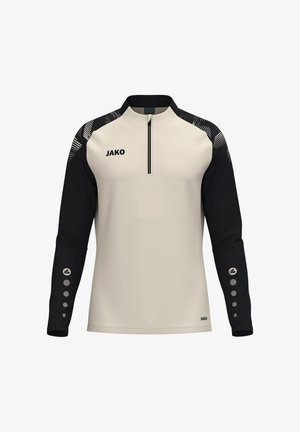 T-shirt de sport à manches longues avec devant beige, manches noires, fermeture éclair courte au col, logo JAKO sur la poitrine et motifs circulaires sur les manches basses.