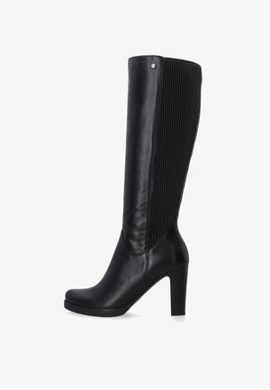 Black knee-high boot with a smooth leather front and ribbed backing, featuring a high block heel and subtle metal accent at the top.