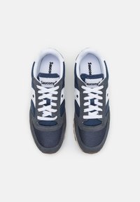 Navy and gray sneakers with white laces, mesh and suede materials. Features a textured surface and a logo accent on the sides.