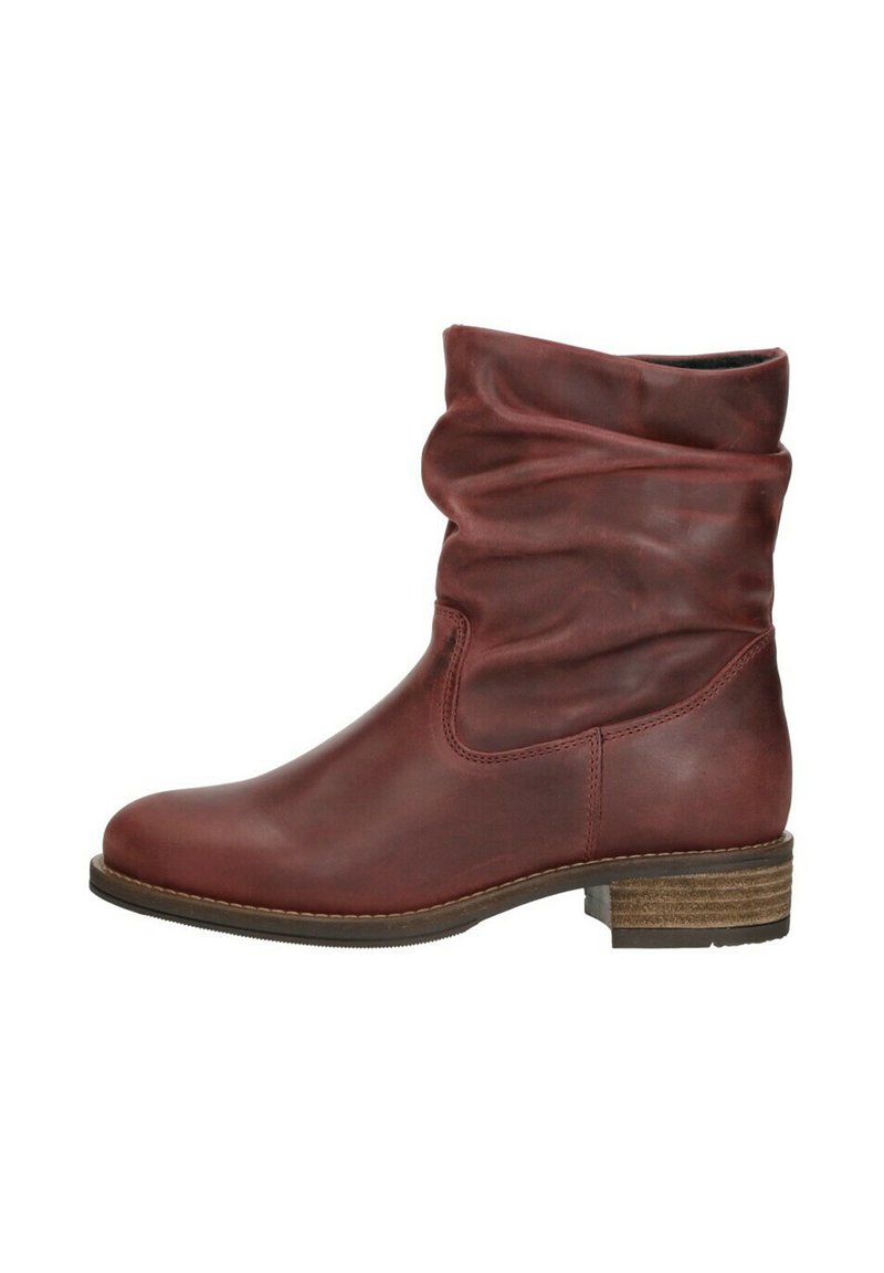Red leather ankle boot with a slouchy design, rounded toe, and a wooden stacked heel. Smooth texture with subtle sheen.