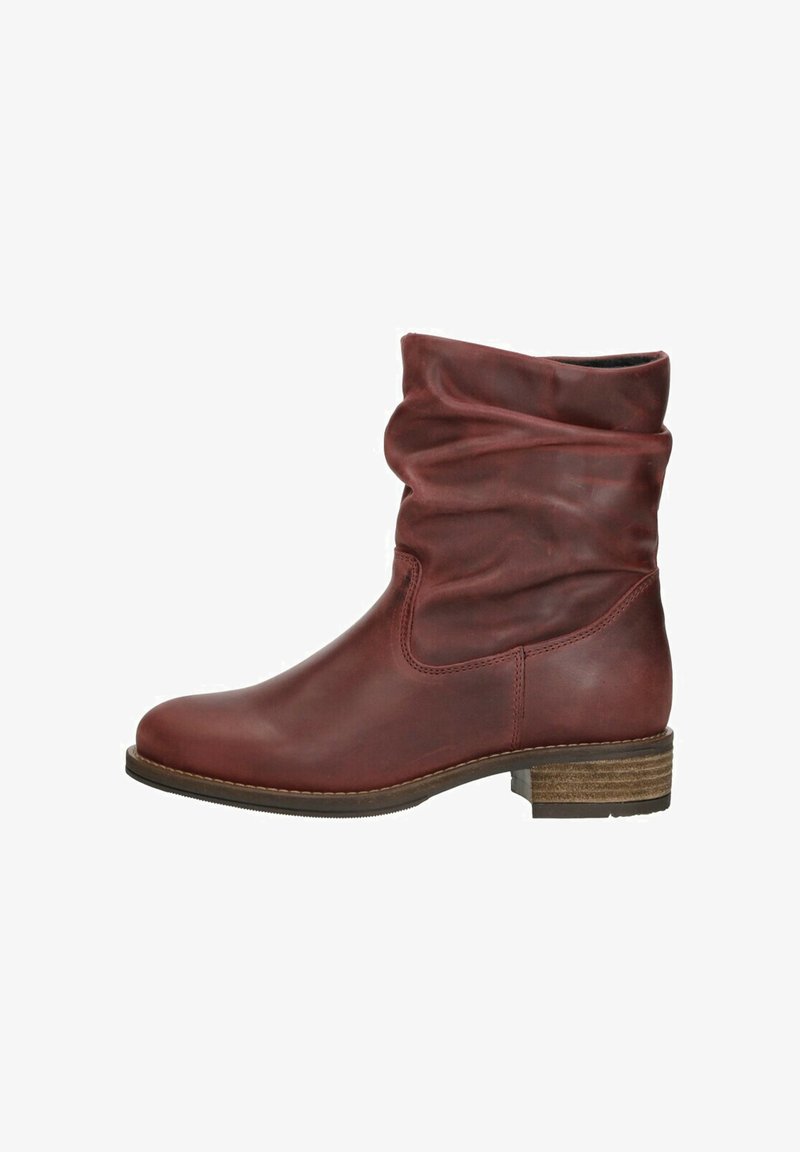 Red leather ankle boot with a slouchy design, rounded toe, and a wooden stacked heel. Smooth texture with subtle sheen.