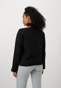 Champion EMOTIONAL DANCE HIGH NECK OPEN SHOULDER - Mikina - schwarz
