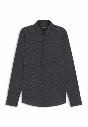 Camicia nera a maniche lunghe con motivo a pois bianchi, collo con bottoni e bottoni blu. Realizzata in tessuto texturizzato.