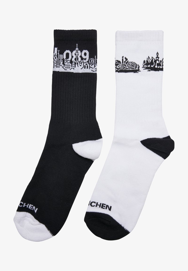 Calcetines de algodón en blanco y negro con patrones de horizonte en la parte superior. El calcetín negro tiene un gráfico blanco, mientras que el calcetín blanco tiene un gráfico negro.
