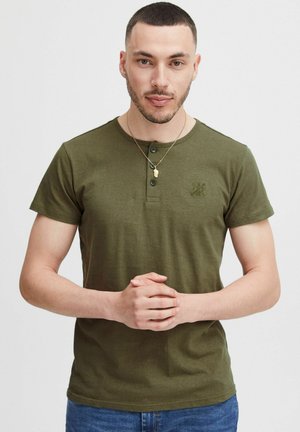 Olivegrünes Kurzarm-Henley-T-Shirt mit rundem Ausschnitt, Knopfleiste und einer strukturierten Logoprint auf der Brust; glattes Baumwollmaterial.