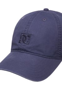 Navy blue cotton baseball cap with a curved visor, featuring an embroidered DC logo on the front and stitched detailing along the edges.