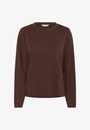 Smeđa majica dugih rukava s okruglim izrezom, koja ima bočne džepove i meku, glatku teksturu. Jednostavan dizajn s minimalnim šavovima.