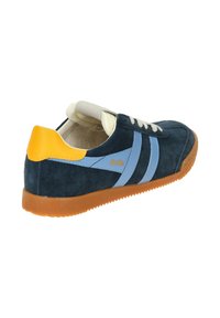 Blue and navy suede sneaker with white laces, gum sole, and yellow heel accent. Features blue stripes and logo on the side.
