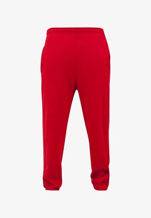 Red sweatpants made from smooth fabric, featuring an elastic waistband, two side pockets, and elastic cuffs at the ankles.