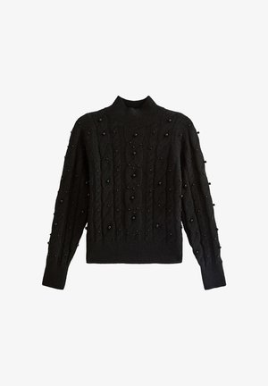 Svart stickad tröja med hög krage, med ett kabelmönster och spridda svarta pärlprydnader på ärmarna. Figursydd stil, långa ärmar.