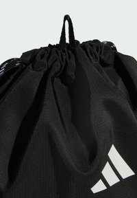 Black drawstring bag with textured fabric, cinched top, and white logo on the side. Features sturdy cords for closure and carrying.