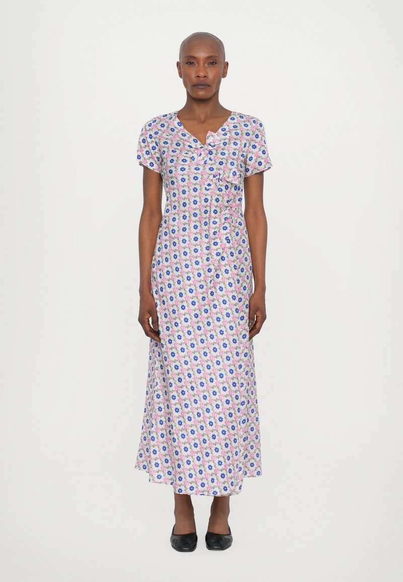 Floral-patterned maxi dress in pink, blue, and white, with a V-neck, short sleeves, and a bow accent at the waist. Material appears lightweight.