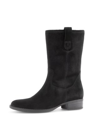 Stivale nero in suede fino al ginocchio con una texture liscia, punta tonda e cuciture minime. Presenta un discreto passante sulla parte superiore e un tacco basso.