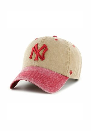 Baseball cap made of beige fabric with a red brim. Features an embroidered red "NY" logo on the front and small red accents.