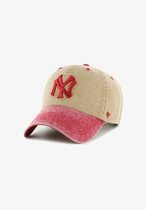 Baseball cap made of beige fabric with a red brim. Features an embroidered red "NY" logo on the front and small red accents.