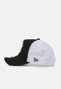 Black and white cap with a curved visor, mesh back, featuring a prominent logo on the front and a small embroidered label on the side.