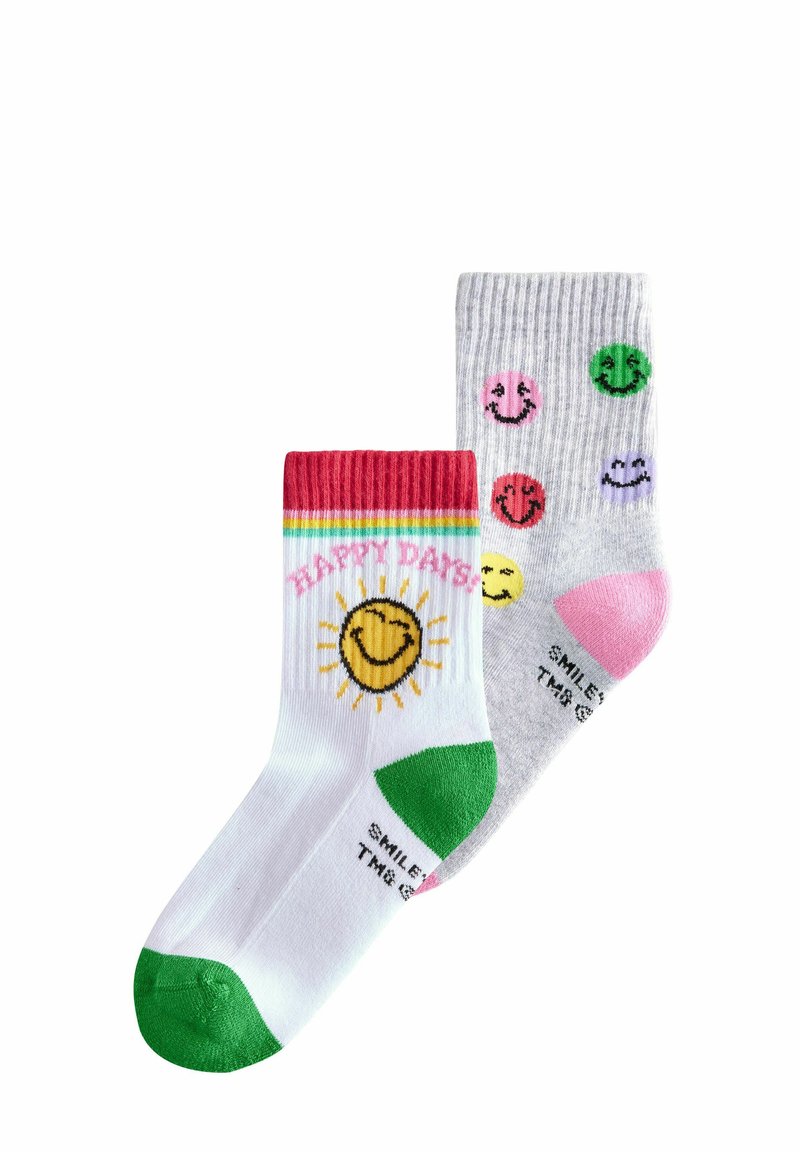 Un paio di calzini colorati: uno bianco con un sole giallo e il testo "GIORNI FELICI", e uno grigio con motivi di faccine sorridenti in rosa, verde e giallo.