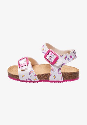 Bijele sandale s uzorcima duga i zvijezda, ružičaste kopče, pluta kao materijal za ulošak i ružičasta guma. Otvoreni dizajn s dva podesiva remena.