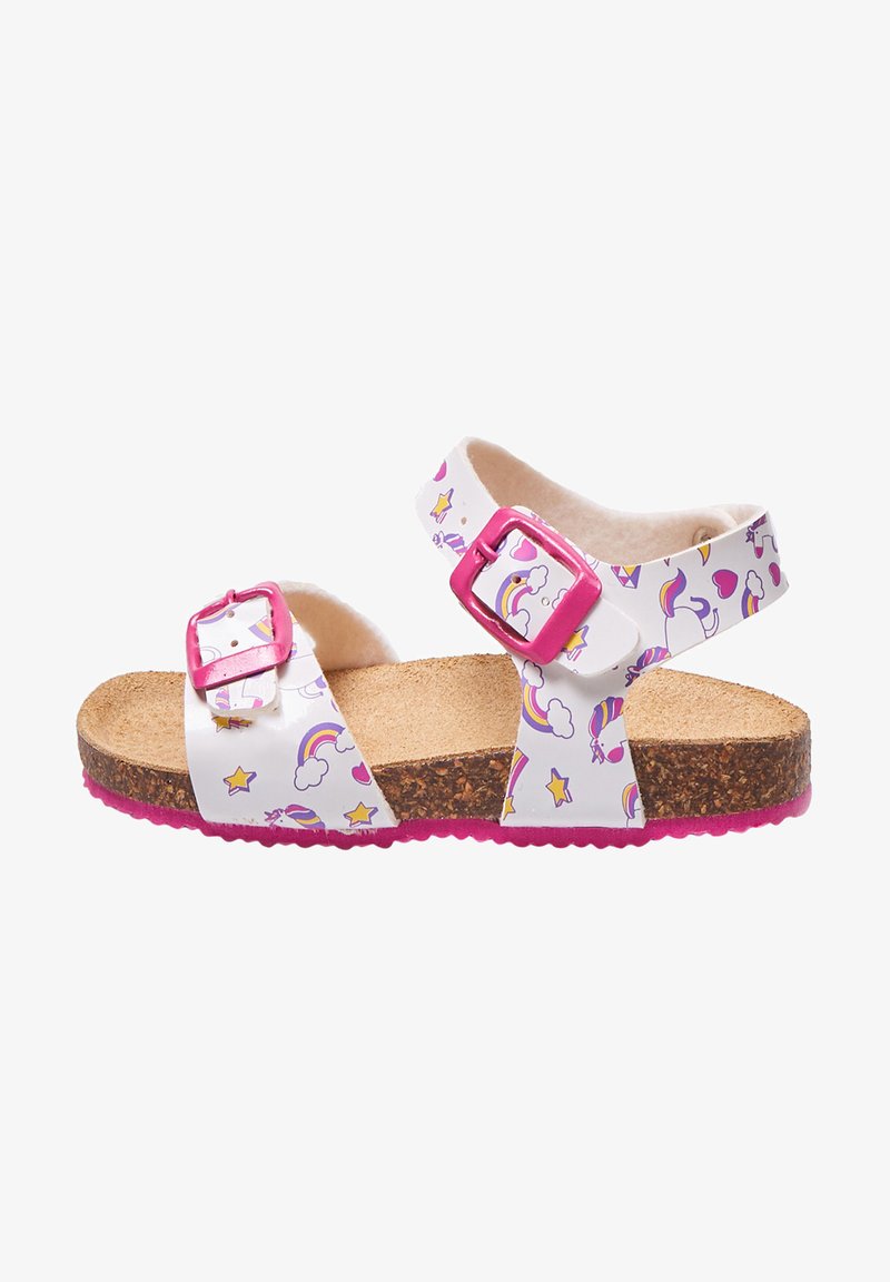 Valge sandaal vikerkaare ja tähe mustritega, roosad pannal, korkjalats ja roosa tallaga. Avatud disain, millel on kaks reguleeritavat rihma.
