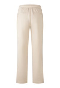 Beige Jogginghosen mit elastischem Bund, zwei Gesäßtaschen und einer glatten, weichen Textur. Gerade Passform ohne zusätzliche Verzierungen.
