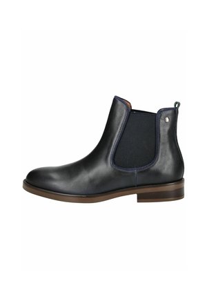 Stivale Chelsea in pelle nera con pannelli elastici sui lati, suola marrone e dettagli di cucitura minimi. Caratterizzato da una linguetta sul retro per facilitare la calzata.