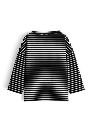 Striped black and white long-sleeved top, featuring wide sleeves and a boat neckline, made of soft cotton fabric.